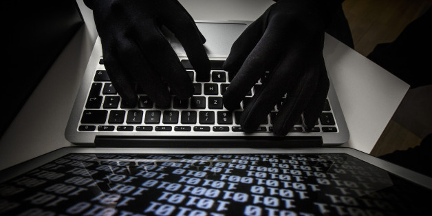 BERLIN, GERMANY - OCTOBER 22: Symbolic feature with topic online crime, data theft and piracy, here a close-up of a keyboard of a laptop with hands in black gloves, on October 22, 2013 in Berlin, Germany. (Photo by Thomas Imo/Photothek via Getty Images)