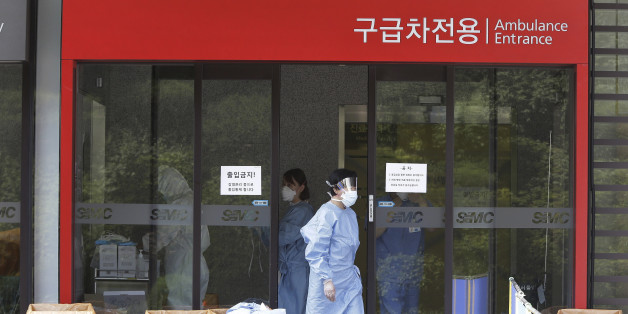 A hospital worker wears a mask as a precaution against the MERS, Middle East Respiratory Syndrome, virus as she comes out from an emergency room of Samsung Medical Center in Seoul, South Korea, Sunday, June 7, 2015. A fifth person in South Korea has died of the MERS virus, as the government announced Sunday it was strengthening measures to stem the spread of the disease and public fear.(AP Photo/Ahn Young-joon)