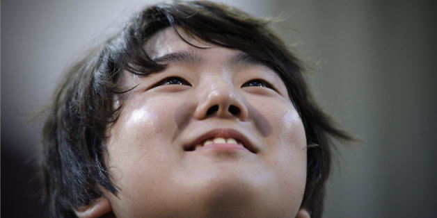 Jin Cho of Korea reacts after playing piano during the third round of XIV International Tchaikovsky Competition in Moscow, Russia, Wednesday, June 29, 2011.(AP Photo/Alexander Zemlianichenko)