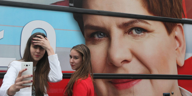 Supporters of the conservative opposition Law and Justice party that is considered a favorite in Sunday general elections take a selfie in front of the campaign bus of Beata Szydlo, the partyâs candidate for prime minister, after a party convention that wrapped up months of campaigning in Warsaw, Poland, on Thursday, Oct. 22, 2015.(AP Photo/Czarek Sokolowski)
