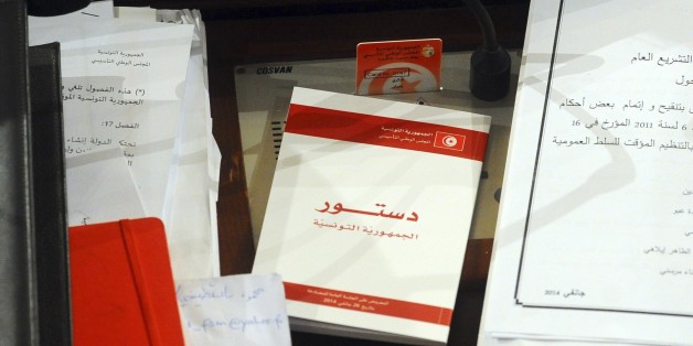 A copy of the new Tunisian Constitution lays on a parliament member's desk at the Constituent Assembly, in Tunis, Monday, Jan.27, 2014. The document is groundbreaking as one of the most progressive constitutions in the Arab world â and for the fact that it got written at all. It passed late Sunday by 200 votes out of 216 in the Muslim Mediterranean country that inspired uprisings across the region after overthrowing a dictator in 2011. (AP Photo/Hassene Dridi)