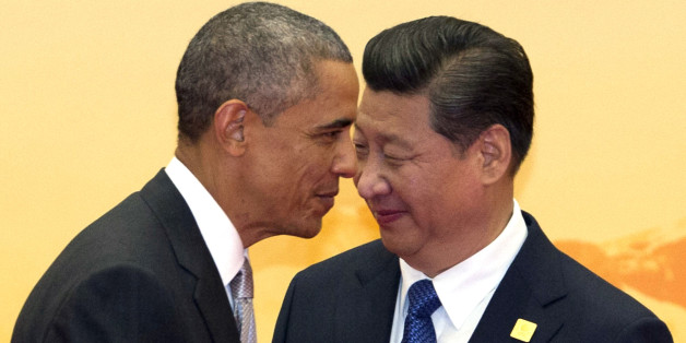 In this Tuesday, Nov. 11, 2014 photo, U.S. President Barack Obama, left, walks past Chinese President Xi Jinping during a welcome ceremony for the Asia-Pacific Economic Cooperation (APEC) summit at the International Convention Center in Yanqi Lake, Beijing, China. (AP Photo/Ng Han Guan)