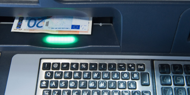 VENICE, ITALY - JUNE 22: Euros are dispensed by a cash machine in a Bank near St Mark's Square on June 22, 2011 in Venice, Italy. Eurozone finance ministers are currently seeking to find a solution to Greece's pressing debt problems, including the prospect of the country's inability to meet its financial obligations unless it gets a fresh, multi-billion Euro loan by July 1. Greece's increasing tilt towards bankruptcy is rattling worldwide financial markets, and leading economists warn that ban