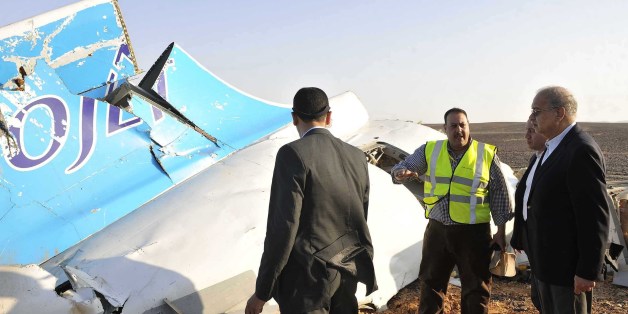 In this image released by the Prime Minister's office, Sherif Ismail, right, looks at the remains of a crashed passenger jet in Hassana Egypt, Friday, Oct. 31, 2015. A Russian aircraft carrying 224 people, including 17 children, crashed Saturday in a remote mountainous region in the Sinai Peninsula about 20 minutes after taking off from a Red Sea resort popular with Russian tourists, the Egyptian government said. There were no survivors.(Suliman el-Oteify, Egypt Prime Minister's Office via AP)