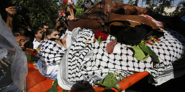 Palestinians carry the body of Raed Jaradat, 22, at the family house during his funeral in the West Bank village of Sa'ir, Hebron, Sunday, Nov. 1, 2015. According to the Israeli military, Jaradat stabbed an Israeli in the neck Monday, Oct. 26, before being shot and killed. (AP Photo/Nasser Shiyoukhi)