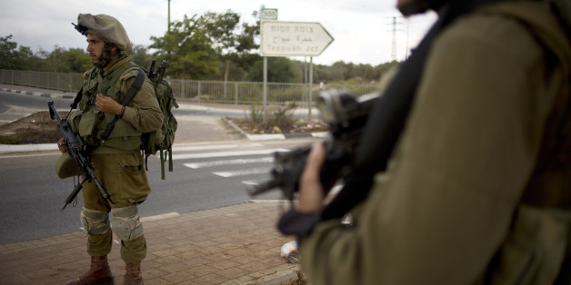 Israeli soldiers secure a checkpoint near the West Bank town of Nablus, Friday, Oct. 30, 2015. Two Palestinians carrying knives ran toward another checkpoint nearby, drawing fire from troops who killed one and critically wounded the other, according to police and a Palestinian medic. (AP Photo/Ariel Schalit)