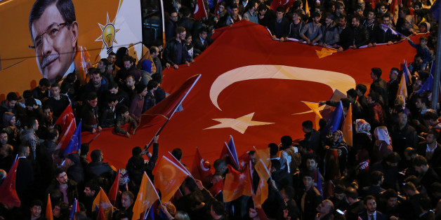 Supporters of Turkey's President Recep Tayyip Erdogan and The Justice and Development Party, (AKP), wave their party and national flags as they celebrate, in Istanbul, Sunday, Nov. 1, 2015. Preliminary results in Turkeyâs parliamentary election suggest that the ruling party has restored its majority in a stunning victory. Turkey's Prime Minister Ahmet Davutoglu has declared victory for his ruling party after preliminary election results showed it restoring its majority in parliament. (AP Ph