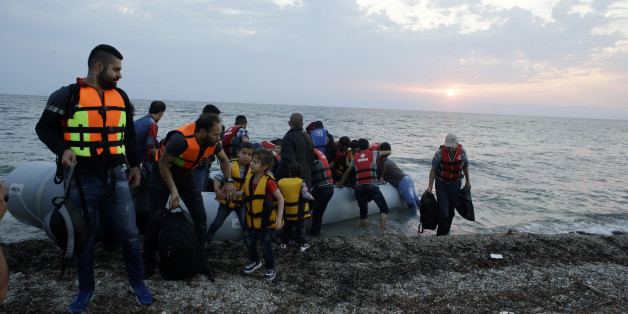 Syrian migrants arrive with an overcrowded dinghy from Turkish coasts at a Mytilene beach, on the northeastern Greek island of Lesvos, early Thursday, June 18, 2015. Around 100,000 migrants have entered Europe so far this year, with some 2,000 dead or missing during their perilous quest to reach the continent. Italy and Greece have borne the brunt of the surge, with many more migrants expected to arrive from June through to September. (AP Photo/Thanassis Stavrakis)