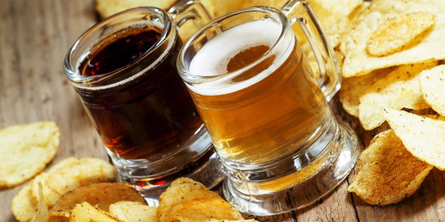 Dark and light beer and chips on the old wooden background, selective focus