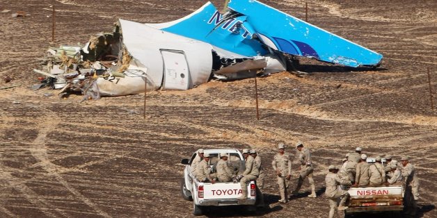 In this photo made available Monday, Nov. 2, 2015, and provided by Russian Emergency Situations Ministry, Egyptian Military on cars approach a plane's tail at the wreckage of a passenger jet bound for St. Petersburg in Russia that crashed in Hassana, Egypt, on Sunday, Nov. 1, 2015. The Russian cargo plane on Monday brought the first bodies of Russian victims killed in a plane crash in Egypt home to St. Petersburg, a city awash in grief for its missing residents. (Maxim Grigoriev/Russian Ministry
