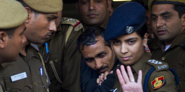 FILE â In this Monday, Dec. 8, 2014 file photo, 32-year-old Shiv Kumar Yadav, center, a driver from the international taxi-booking service Uber, is escorted by police to be produced to a court in New Delhi, India. A New Delhi court on Tuesday, Jan. 13, 2015, charged the Uber cab driver with the rape, kidnapping and criminal intimidation of a 25-year-old woman who hired the taxi service for a ride home from a dinner engagement last month. (AP Photo/Saurabh Das, File)