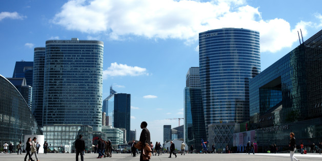 People walk in La Defense business district, west of Paris, Wednesday, April 9, 2014. La Défense is Europe's largest purpose-built business district. (AP Photo/Thibault Camus)