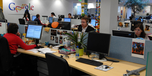 Employees work in one of the open space work areas in the offices of Google, at their European headquarters in Dublin, Monday, April 10, 2006. Dublin's new Docklands, where scores of cranes feed the frenzy for new hotels and gleaming office blocks, offer a vibrant microcosm of Ireland's rise from Europe's emigration blackspot to its "brain gain" capital. Poles, Iranians, Swedes, Chinese, Nigerians are among the throngs performing tasks ranging from hawking fast food to writing software code. In