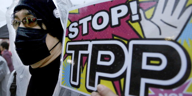 FILE - In this April 22, 2104 file photo, a protester holds a placard during a rally against the Trans-Pacific Partnership (TPP) in Tokyo. Just over two decades after lobbying unsuccessfully against the North American Free Trade Agreement, U.S. labor unions are again voicing strong reservations to a proposed major trade-liberalization deal. (AP Photo/Shizuo Kambayashi, File)