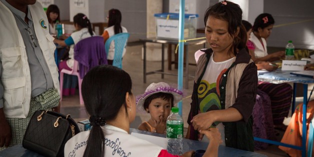 HLAINGTHAYAR, MYANMAR - NOVEMBER 08: A woman has her finger print stamped at the Nawaday Garden community center polling station in Hlaingtaryar township during Myanmar's first free and fair election on November 8, 2015 near Hlaingthayar, Myanmar. Hlaingthayar is one of Yangon's main industrial zones and home to several unregistered factory workers who were unable to vote. The elections will be Myanmar's first openly contested polls in 25 years, following decades of military rule. (Photo by Lauren DeCicca/Getty Images)