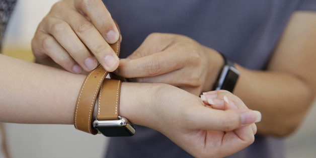Letty Liang, of San Francisco, tries on the new Apple Watch Hermes at the Apple store Monday, Oct. 5, 2015, in Stanford, Calif. The watch, which starts at $1100, went on sale Monday. (AP Photo/Eric Risberg)
