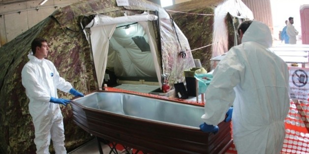 Des experts italiens s'apprêtent à autopsier des migrants dans une tente réfrigérée le 5 novembre 2015 à Melilli, en Sicile