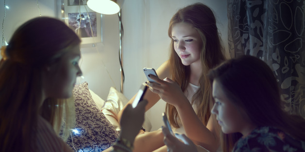 teenage girls on their phones