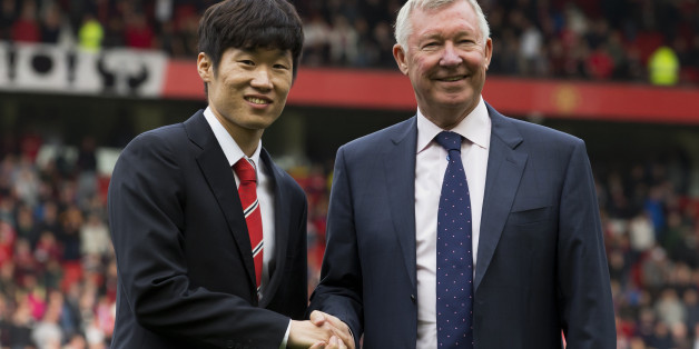 Manchester United former player Park Ji-sung, left, shakes hands with former manager Alex Ferguson as Park is introduced as a new ambassador for the club before the team's English Premier League soccer match against Everton at Old Trafford Stadium, Manchester, England, Sunday Oct. 5, 2014. (AP Photo/Jon Super)