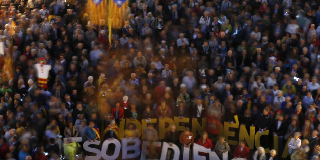 People hold words meaning "Independence and Disobedience" during a rally in Barcelona, Spain, Tuesday, Oct. 13, 2015. Thousands of pro-Catalan independence supporters are protesting the opening of a court investigation into the regional governmentâs staging of a symbolic referendum on secession from Spain last year. (AP Photo/Manu Fernandez)