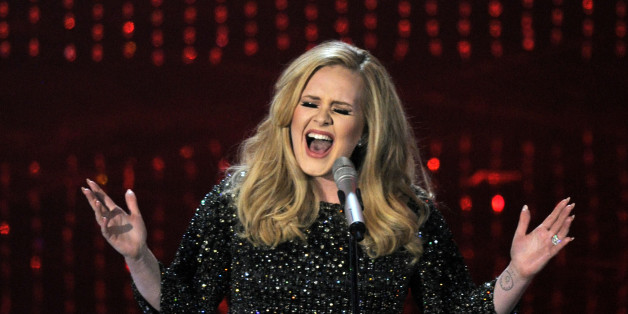 FILE - In this Feb. 24, 2013 file photo, Adele performs during the Oscars at the Dolby Theatre in Los Angeles. Adeleâs âHelloâ single has become the first song to sell one million tracks in a week. Her comeback track sold 1.11 million digital songs, setting a new record. Her complete album "25," will be released on Nov. 20. (Photo by Chris Pizzello/Invision/AP, File)