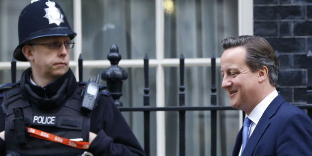 A police officer stands by as Britain's Prime Minister David Cameron leaves 10 Downing Street in London, Thursday, Nov. 20, 2014. David Cameron will attend a Liaison Committee Thursday, the meeting focuses on the Governance of the UK in the light of the Scottish Referendum. (AP Photo/Kirsty Wigglesworth)