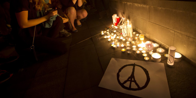 People light candles in Hong Kong, Saturday, Nov. 14, 2015, to mourn for the victims killed in Friday's attacks in Paris. French President Francois Hollande said more than 120 people died Friday night in shootings at Paris cafes, suicide bombings near France's national stadium and a hostage-taking slaughter inside a concert hall. (AP Photo/Kin Cheung)