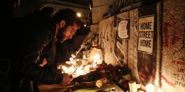 Mourners light candles at a Place de la République in Paris, France on Saturday, Nov. 14, 2015. French President Francois Hollande blamed Islamic State militants for coordinated strikes in Paris that left 127 dead, bringing the conflict with the radical group to the heart of the Western world. Photographer: Simon Dawson/Bloomberg via Getty Images