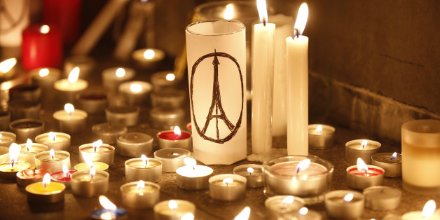 Candles are lit as people gather in Hong Kong, Saturday, Nov. 14, 2015, to mourn for the victims killed in Friday's attacks in Paris. French President Francois Hollande said more than 120 people died Friday night in shootings at Paris cafes, suicide bombings near France's national stadium and a hostage-taking slaughter inside a concert hall. (AP Photo/Kin Cheung)