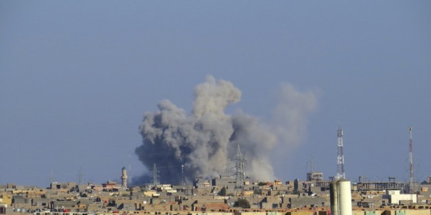Smoke rises from Islamic State positions following a U.S.-led coalition airstrike during a military operation launched by Iraq Anti-terrorism forces to regain control the western suburbs of Ramadi, the capital of Iraq's Anbar province, 70 miles (115 kilometers) west of Baghdad, Iraq, Saturday, Nov. 14, 2015. (AP Photo/Osama Sami)