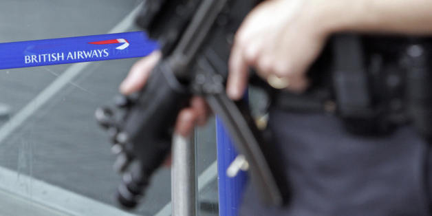 LONDON, United Kingdom: Armed British police patrol near the departures area of Terminal 4 at London's Heathrow airport, in south-east England, 14 August 2006. British and US authorities eased curbs for airline passengers Monday as Britain lowered its terror alert, deeming the threat of attack to be no longer imminent though still 'highly likely.' However, officials at Heathrow and Gatwick, the main airports serving the capital London, reported further flight cancelations and delays as security measures remained tight, albeit less stringent, for a fifth day. AFP PHOTO/LEON NEAL (Photo credit should read Leon Neal/AFP/Getty Images)