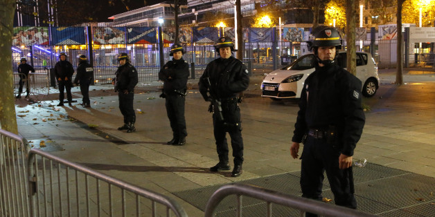Police officers secure the Stade de France stadium during the international friendly soccer France against Germany, Friday, Nov. 13, 2015 in Saint Denis, outside Paris. Two police officials say at least 11 people have been killed in shootouts and other violence around Paris. Police have reported shootouts in at least two restaurants in Paris. At least two explosions have been heard near the Stade de France stadium, and French media is reporting of a hostage-taking in the capital. (AP Photo/Michel Euler)