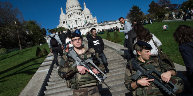PARIS, FRANCE - NOVEMBER 15: French soldiers stand guard at the 'Sacre-Coeur' cathedral on November 15, 2015 in Paris, France. As France observes three days of national mourning members of the public continue to pay tribute to the victims of Friday's deadly attacks. A special service for the families of the victims and survivors is to be held at Paris's Notre Dame Cathedral later on Sunday. (Photo by David Ramos/Getty Images)