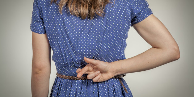 Young woman crossing her fingers behind her back