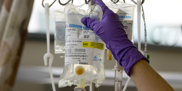 A nurse places Judith Bernstein's chemotherapy medication on an intravenous stand at the Fox Chase Cancer Center in Philadelphia on Tuesday, Aug. 4, 2015. Bernstein has had eight different types of cancer over the last two decades, all treated successfully. More people are surviving cancer and living long enough to get it again, because the risk of cancer rises with age. (AP Photo/Matt Rourke)