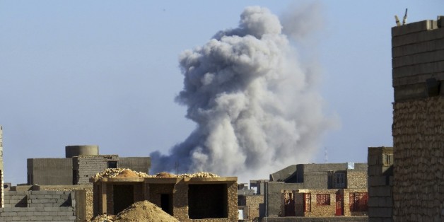Smoke rises from Islamic State positions following a U.S.-led coalition airstrike during a military operation launched by Iraq Anti-terrorism forces to regain control the western suburbs of Ramadi, the capital of Iraq's Anbar province, 70 miles (115 kilometers) west of Baghdad, Iraq, Saturday, Nov. 14, 2015. (AP Photo/Osama Sami)