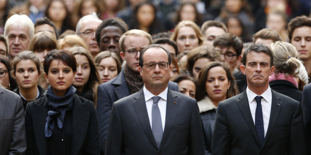 French President Francois Hollande, center, flanked by French Prime Minister Manuel Valls, right, and French Education Minister Najat Vallaud-Belkacem, center left, stands among students during a minute of silence in the courtyard of the Sorbonne University in Paris, Monday, Nov. 16 2015. A minute of silence was observed throughout the country in memory of the victims of last Friday's attack. (Guillaume Horcajuelo, Pool via AP)
