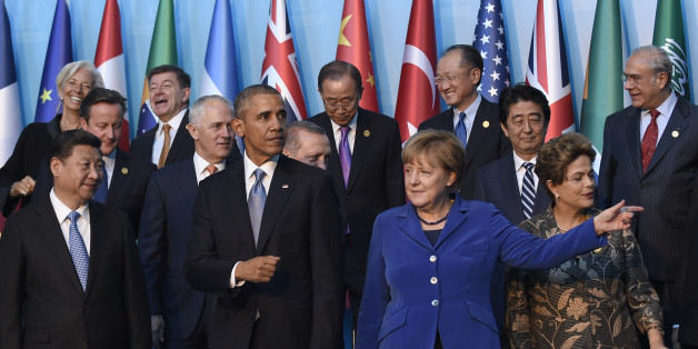 President Barack Obama, center, walks with Germanyâs Chancellor Angela Merkel, in blue, and other leaders as they try to figure out which way to go following the G20 Summit group photo in Antalya, Turkey, Sunday, Nov. 15, 2015. Obama is attending the G20 Summit while on a nine-day foreign trip that also includes stops in the Philippines and Malaysia for other global security and economic summits. (AP Photo/Susan Walsh)