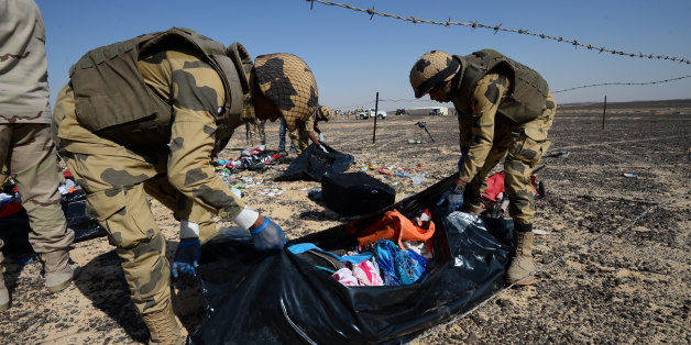 FILE - In this file Russian Emergency Situations Ministry photo, made available on Monday, Nov. 2, 2015 Egyptian soldiers collect personal belongings of plane crash victims at the crash site of a passenger plane bound for St. Petersburg in Russia that crashed in Hassana, Egypt's Sinai Peninsula. The Russian passenger plane that crashed in Egypt was brought down by a homemade bomb placed on board in a "terrorist" act, the head of Russia's FSB security service told President Vladimir Putin on Tues