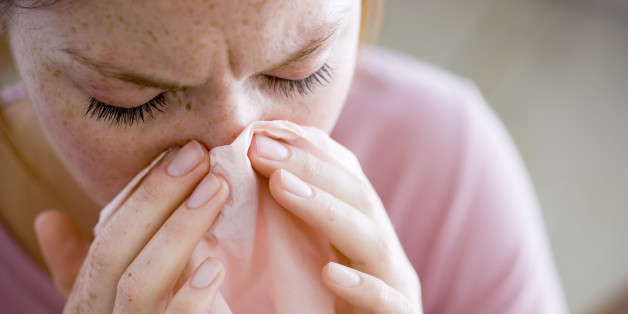 Woman blowing nose