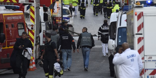 Policemen and firemen are pictured in the northern Paris suburb of Saint-Denis city center, on November 18, 2015, as French Police special forces raid an appartment, hunting those behind the attacks that claimed 129 lives in the French capital five days ago. At least one person was killed in an apartment targeted in the operation aimed at the suspected mastermind of the attacks, Belgian Abdelhamid Abaaoud, and police had been wounded in the shootout. AFP PHOTO / LIONEL BONAVENTURE (Photo credit should read LIONEL BONAVENTURE/AFP/Getty Images)