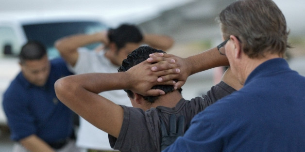 Illegal immigrants from El Salvador are searched prior to boarding an MD-80 aircraft for a repatriation flight of 80 illegal immigrants back to their home country, Tuesday, June 26, 2012 at Phoenix-Mesa Gateway Airport in Mesa, Ariz. Immigration and Customs Enforcement (ICE) operate four to five repatriation flights weekly out of Mesa to El Salvador, Guatemala and Honduras. Shackled violent offenders, minors and women are separated on the flight and are turned over to El Salvador's immigration officers upon arrival. (AP Photo/Matt York)