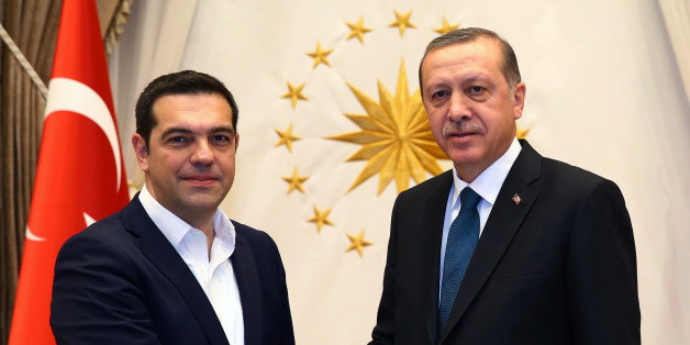 Greece's Prime Minister Alexis Tsipras, left, and Turkish President Recep Tayyip Erdogan shake hands before a meeting in Ankara, Turkey, Wednesday, Nov. 18, 2015. Turkey and Greece have agreed to cooperate to prevent the "human tragedy" suffered by thousands of migrants who risk lives crossing the Aegean Sea on their way to Europe. Davutoglu and Tsipras said however, that the refugee burden cannot be placed on the two countries' shoulders alone, insisting that other European nations share the responsibility.(Presidential Press Service/Pool Photo via AP)