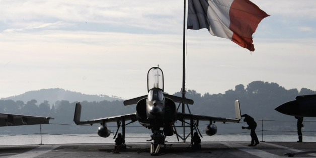 A French sailor checks a Super-Etendard jetflighter on the deck of France's nuclear-powered aircraft carrier Charles de Gaulle before to leave its home port of Toulon, southern France, Wednesday, Nov.18, 2015. France has decided to deploy its aircraft carrier in the eastern Mediterranean sea for fighting Islamic State group.(AP Photo/Claude Paris)