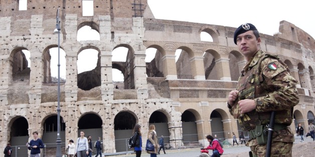 An Italian soldier patrols in front of the Colosseum in Rome, Saturday, Nov. 14, 2015. Italy's top security official says Italy has heightened security inside Italy and along its borders, especially with France, following the attacks in Paris. Interior Minister Angelino Alfano said that 700 soldiers were being deployed immediately to Rome as a deterrent and additional security measures will be taken into consideration for the upcoming Jubilee year declared by Pope Francis that is expected to bri
