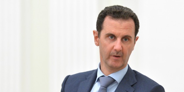 In this photo taken on Tuesday, Oct. 20, 2015, Syria President Bashar Assad gestures during his meeting with Russian President Vladimir Putin, back to the camera, in the Kremlin in Moscow, Russia. President Bashar Assad was in Moscow, in his first known trip abroad since the war broke out in Syria in 2011, to meet his strongest ally Russian leader Vladimir Putin. The two leaders stressed that the military operations in Syria_ in which Moscow is the latest and most powerful addition_ must lead to a political process. (Alexei Druzhinin, RIA-Novosti, Kremlin Pool Photo via AP)