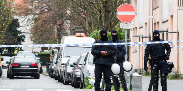 Armed police guard a street in Brussels on Monday, Nov. 16, 2015. A major action with heavily armed police is underway in the Brussels neighborhood of Molenbeek amid a manhunt for a suspect of the Paris attacks. (AP Photo/Geert Vanden Wijngaert)