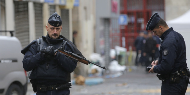 Police officers guard the street of Wednesday's raid on an apartment in Paris suburb Saint-Denis, Thursday Nov.19, 2015. With France still reeling from last week's deadly attacks in Paris, Prime Minister Manuel Valls warned Thursday that Islamic extremists might at some point use chemical or biological weapons, and urged lawmakers to extend a national state of emergency by three months. (AP Photo/Christophe Ena)