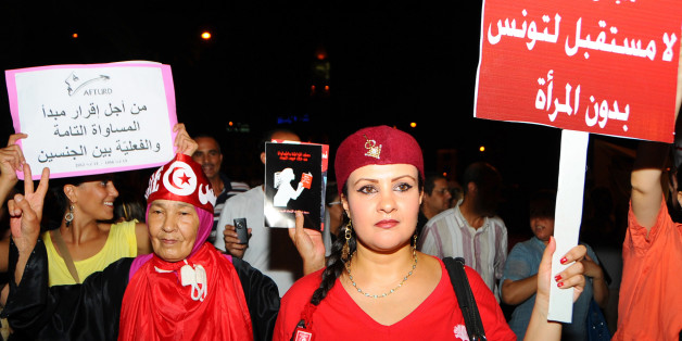In this Monday, Aug. 13, 2012 photo Tunisian women carry placards protesting their rights which read: "no future for Tunisia without women" and right, "equal rights for men and women" as they march in Tunis. Tunisians rallied to protest against what they see as a push by the Islamist-led government for constitutional changes that would degrade women's status. (AP Photo/Hassene Dridi)