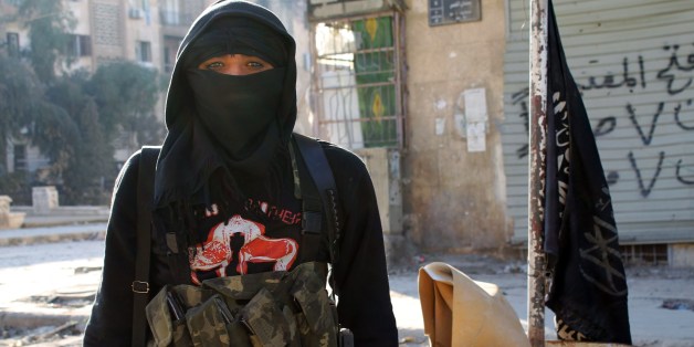 A member of jihadist group Al-Nusra Front stands in a street of the northern Syrian city of Aleppo on January 11, 2014. Fighting pitting the Islamic State of Iraq and the Levant (ISIL) against other rebel groups -- including Al-Nusra Front, which is also linked to Al-Qaeda but is seen as more moderate -- broke out in Syria last week. AFP PHOTO / BARAA AL-HALABI (Photo credit should read BARAA AL-HALABI/AFP/Getty Images)